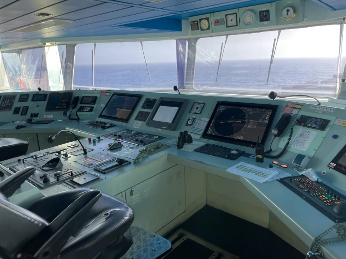 the control room of a ship with multiple monitors
